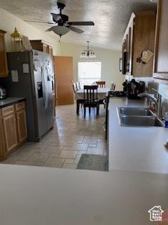 165 S 200th Ct W, Vernal, UT 84078 - kitchen featuring a ceiling fan, appliances with stainless steel finishes, dark countertops, brown cabinets, and a chandelier