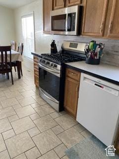 165 S 200th Ct W, Vernal, UT 84078 - kitchen featuring appliances with stainless steel finishes, light countertops, and brown cabinetry