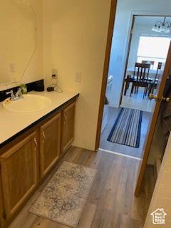 165 S 200th Ct W, Vernal, UT 84078 - bathroom featuring wood finished floors, a chandelier, and vanity