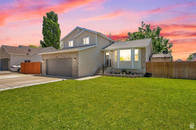 2817 W 1475 N, Layton, UT 84041 - split level home with an attached garage, brick siding, and concrete driveway