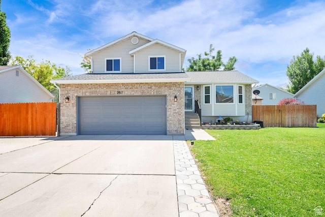 2817 W 1475 N, Layton, UT 84041 - view of front of property with concrete driveway, brick siding, an attached garage, and a shingled roof
