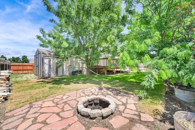 2817 W 1475 N, Layton, UT 84041 - fenced backyard with a fire pit, a storage unit, a wooden deck, and a patio area