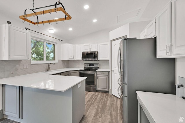2817 W 1475 N, Layton, UT 84041 - kitchen with appliances with stainless steel finishes, backsplash, recessed lighting, light wood-style floors, and lofted ceiling