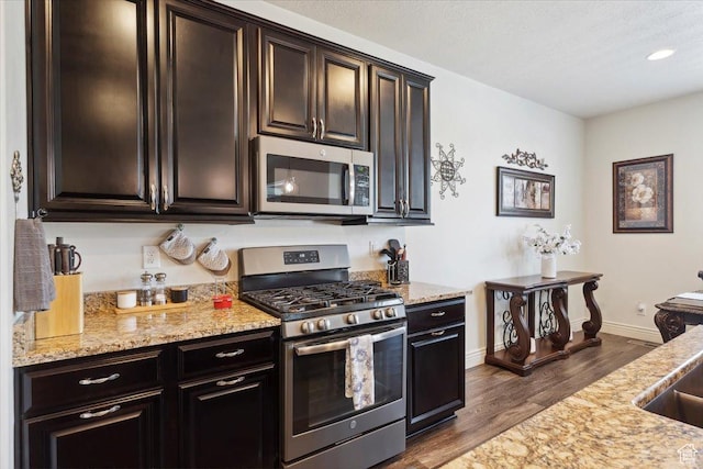 2892 W 2500 N, Clinton, UT 84015 - kitchen with appliances with stainless steel finishes, dark wood-style floors, light stone counters, recessed lighting, and dark brown cabinetry
