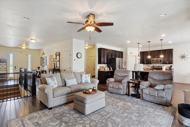 2892 W 2500 N, Clinton, UT 84015 - living area with wood finished floors, ceiling fan, a textured ceiling, and recessed lighting