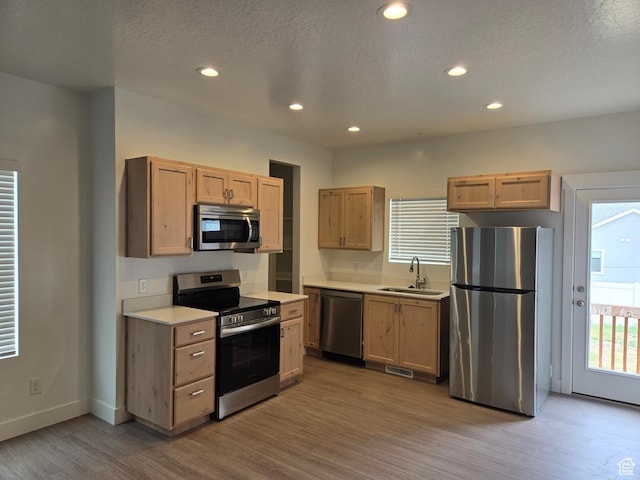 1561 S Sageberry Dr, Santaquin, UT 84655 - kitchen with stainless steel appliances, light wood finished floors, light countertops, recessed lighting, and a textured ceiling