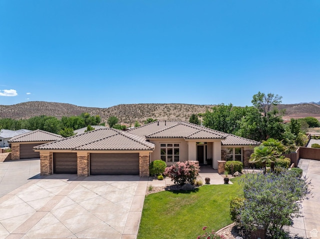 1285 Summerwood Cir, Santa Clara, UT 84765 - mediterranean / spanish house featuring a tile roof, a mountain view, concrete driveway, and stone siding