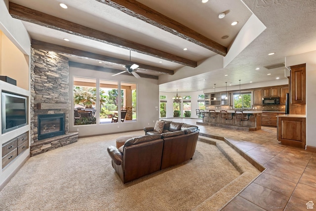 1285 Summerwood Cir, Santa Clara, UT 84765 - living room featuring recessed lighting, a fireplace, beamed ceiling, and a ceiling fan