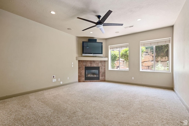 1285 Summerwood Cir, Santa Clara, UT 84765 - unfurnished living room with carpet flooring, a tile fireplace, a textured ceiling, ceiling fan, and recessed lighting
