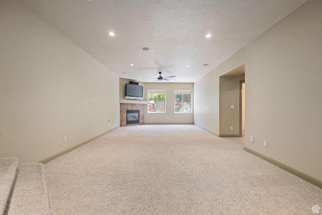 1285 Summerwood Cir, Santa Clara, UT 84765 - unfurnished living room with a ceiling fan, carpet, a tiled fireplace, recessed lighting, and a textured ceiling