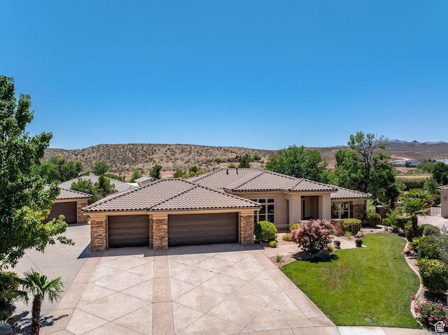 1285 Summerwood Cir, Santa Clara, UT 84765 - mediterranean / spanish home with stone siding, a tile roof, concrete driveway, a mountain view, and a garage