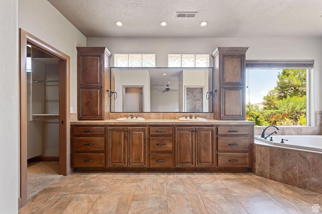 1285 Summerwood Cir, Santa Clara, UT 84765 - full bathroom with double vanity, a bath, a textured ceiling, ceiling fan, and recessed lighting