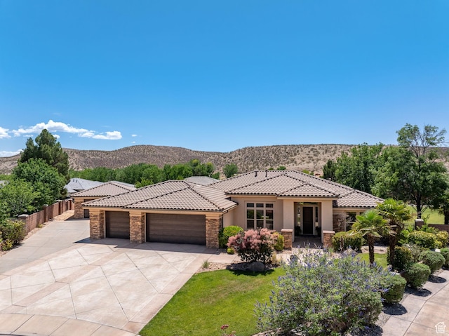 1285 Summerwood Cir, Santa Clara, UT 84765 - view of front of property with stone siding, a tile roof, a garage, and stucco siding