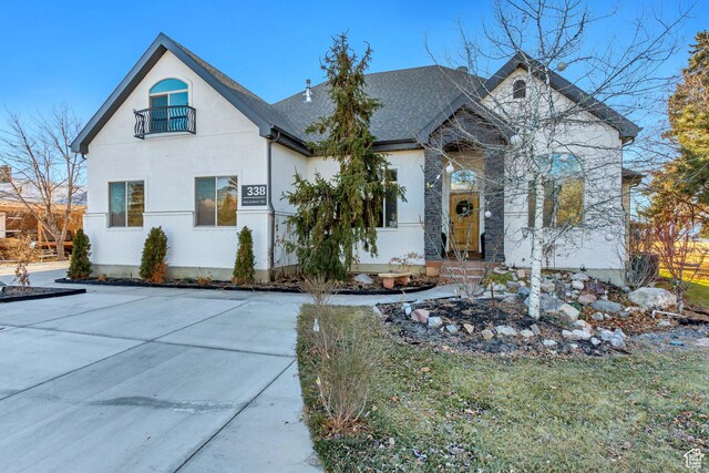 338 S Holdaway Rd, Vineyard, UT 84059 - french country style house featuring a shingled roof, stucco siding, and stone siding