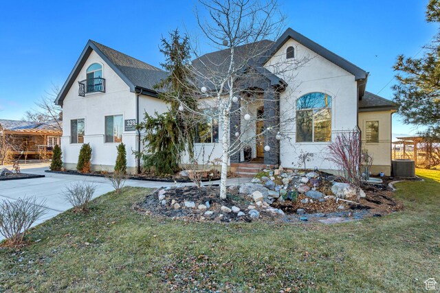 338 S Holdaway Rd, Vineyard, UT 84059 - french country inspired facade featuring a front lawn, stucco siding, and roof with shingles
