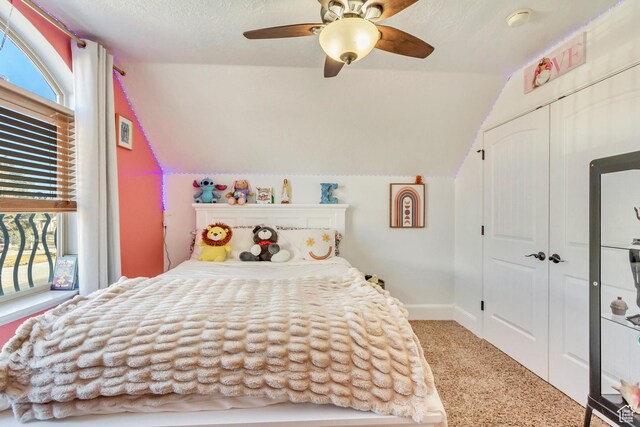 338 S Holdaway Rd, Vineyard, UT 84059 - carpeted bedroom with lofted ceiling, multiple windows, a closet, and a ceiling fan