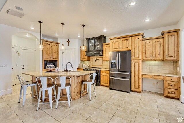 338 S Holdaway Rd, Vineyard, UT 84059 - kitchen with stainless steel appliances, exhaust hood, backsplash, light stone countertops, and recessed lighting