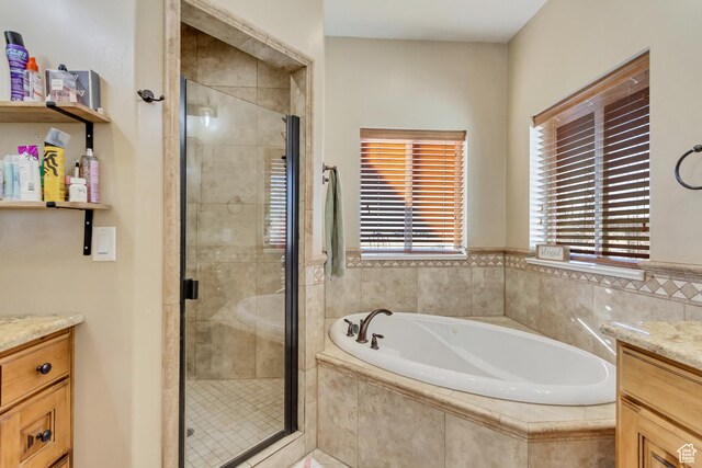 338 S Holdaway Rd, Vineyard, UT 84059 - bathroom featuring vanity, a bath, and a shower stall