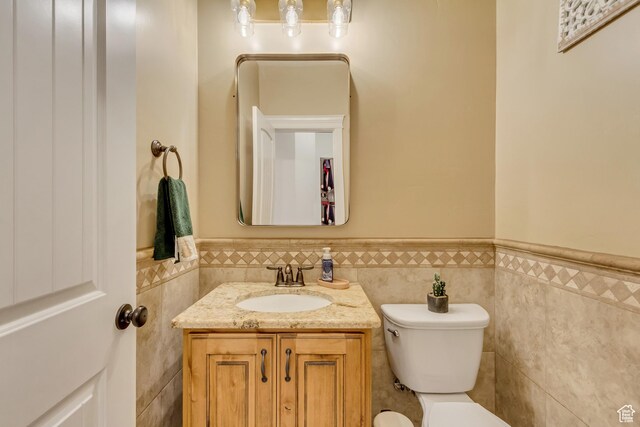 338 S Holdaway Rd, Vineyard, UT 84059 - half bath featuring tile walls, a wainscoted wall, and vanity