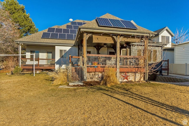 338 S Holdaway Rd, Vineyard, UT 84059 - view of front of house featuring a shingled roof, a ceiling fan, a front yard, and a deck
