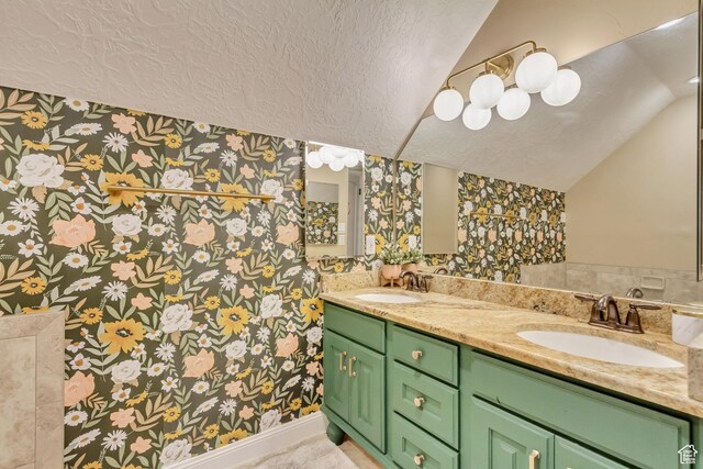 338 S Holdaway Rd, Vineyard, UT 84059 - full bath featuring wallpapered walls, a textured ceiling, lofted ceiling, and double vanity