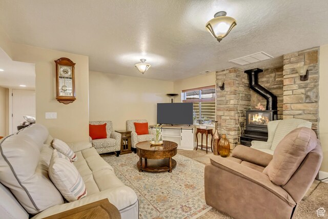 338 S Holdaway Rd, Vineyard, UT 84059 - living room with a wood stove, light carpet, and a textured ceiling