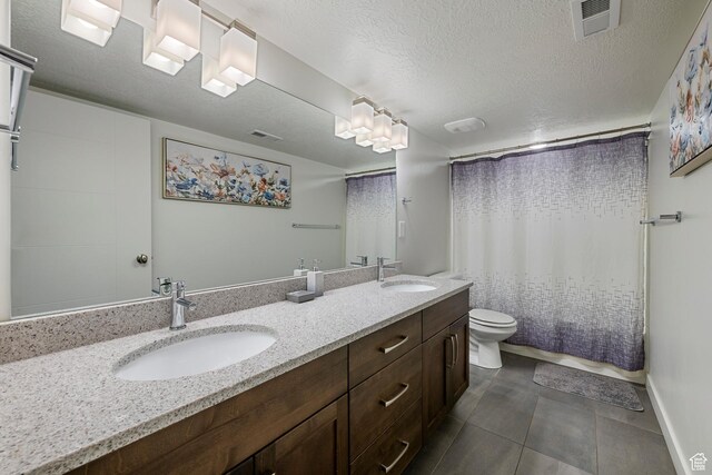 6691 Woods Rose Dr Unit 45, Park City, UT 84098 - bathroom featuring double vanity, a textured ceiling, a shower with curtain, and tile patterned flooring