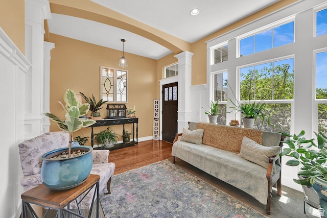 514 Rigby Rd, Farmington, UT 84025 - living room featuring decorative columns, wood finished floors, arched walkways, and recessed lighting