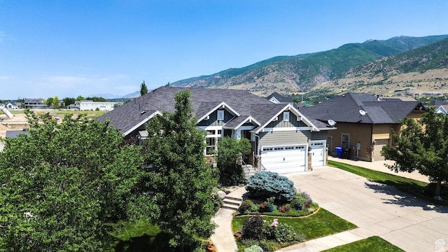 514 Rigby Rd, Farmington, UT 84025 - view of front of home with concrete driveway, a mountain view, and board and batten siding