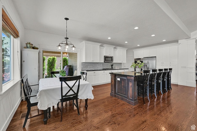 514 Rigby Rd, Farmington, UT 84025 - kitchen with stainless steel appliances, dark countertops, plenty of natural light, tasteful backsplash, and recessed lighting