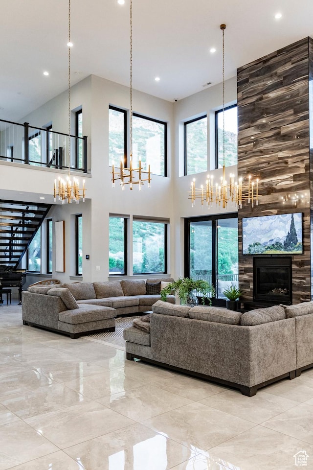 1621 E Box Elder Cir, Alpine, UT 84004 - living room with a chandelier, a high ceiling, recessed lighting, and a fireplace