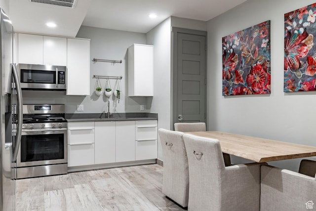 1621 E Box Elder Cir, Alpine, UT 84004 - kitchen featuring stainless steel appliances, white cabinets, recessed lighting, light wood-style flooring, and modern cabinets