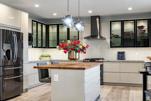 1621 E Box Elder Cir, Alpine, UT 84004 - kitchen with refrigerator with ice dispenser, butcher block counters, wall chimney range hood, gas range, and tasteful backsplash