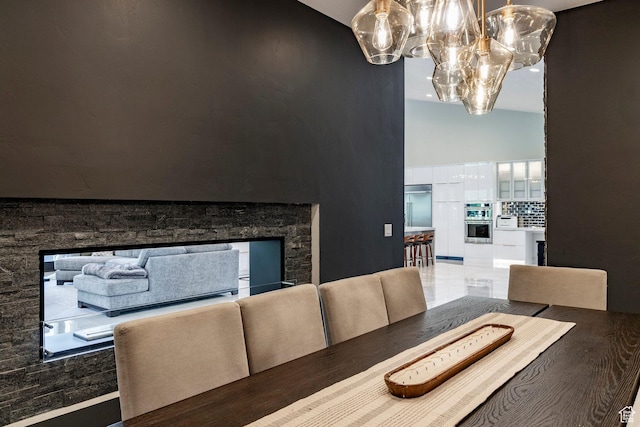 1621 E Box Elder Cir, Alpine, UT 84004 - dining room featuring a chandelier, high vaulted ceiling, and a stone fireplace