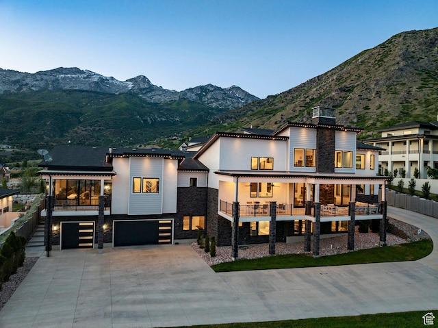 1621 E Box Elder Cir, Alpine, UT 84004 - back of property featuring stone siding, an attached garage, and a mountain view