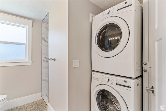 1393 E Davis Ave, Logan, UT 84321 - washroom with estacked washer and dryer and a textured ceiling