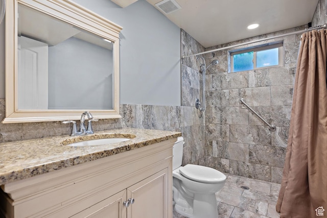9096 N Canyon Rd, Cedar Hills, UT 84062 - bathroom featuring tile walls, vanity, a tile shower, and wainscoting