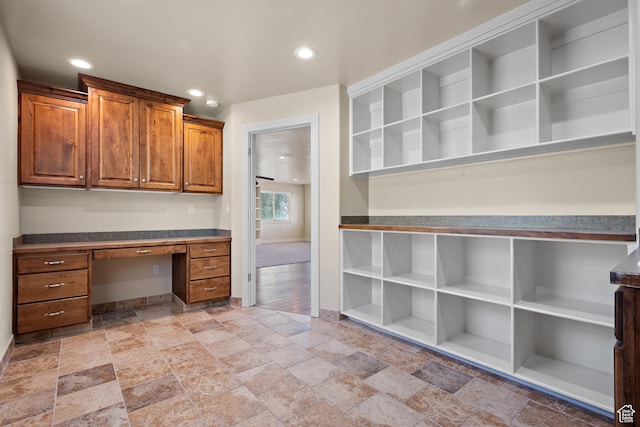 9096 N Canyon Rd, Cedar Hills, UT 84062 - unfurnished office featuring built in desk, stone tile floors, and recessed lighting