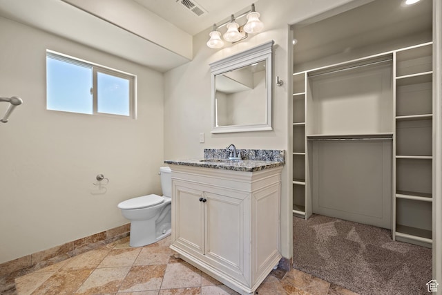 9096 N Canyon Rd, Cedar Hills, UT 84062 - bathroom with stone tile floors, vanity, and a closet