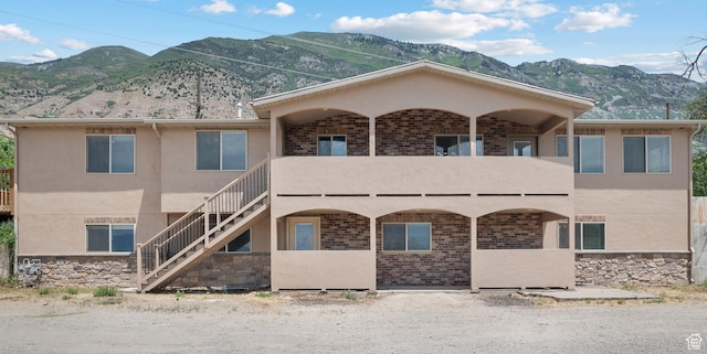 9096 N Canyon Rd, Cedar Hills, UT 84062 - view of front of house featuring a mountain view, stairway, stucco siding, and a balcony