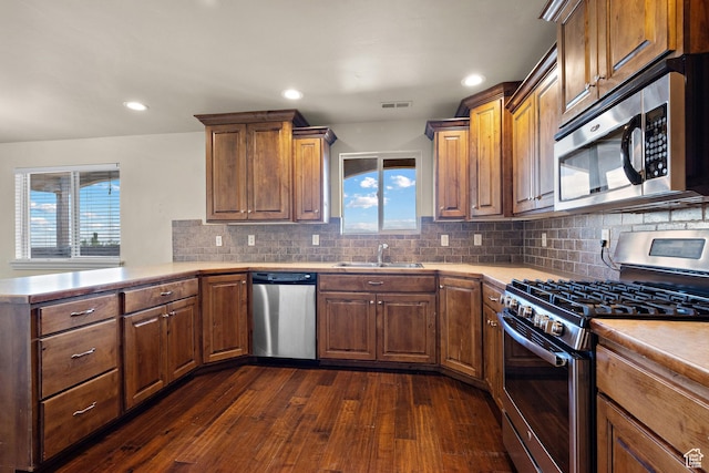 9096 N Canyon Rd, Cedar Hills, UT 84062 - kitchen featuring stainless steel appliances, healthy amount of natural light, dark wood-style flooring, light countertops, and recessed lighting