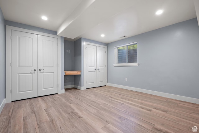 9096 N Canyon Rd, Cedar Hills, UT 84062 - unfurnished bedroom featuring multiple closets, light wood-style floors, and recessed lighting