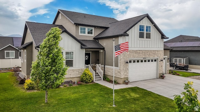 4655 N Ibapah St, Eagle Mountain, UT 84005 - view of front facade featuring board and batten siding, stone siding, concrete driveway, and a front lawn