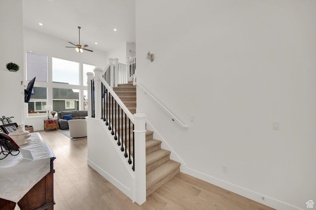 4655 N Ibapah St, Eagle Mountain, UT 84005 - stairs with wood finished floors, ceiling fan, recessed lighting, and a towering ceiling