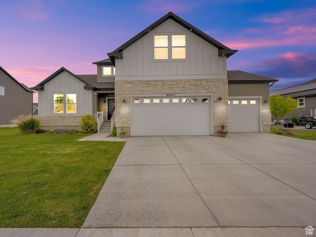 4655 N Ibapah St, Eagle Mountain, UT 84005 - view of front of property with stone siding, board and batten siding, a lawn, and driveway