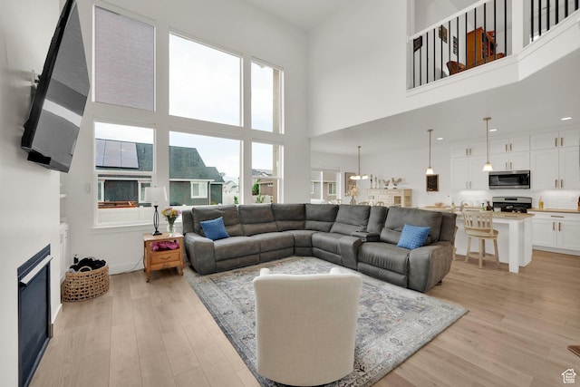 4655 N Ibapah St, Eagle Mountain, UT 84005 - living room featuring light wood-style floors and a towering ceiling