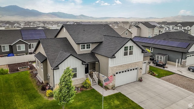 4655 N Ibapah St, Eagle Mountain, UT 84005 - view of front of home with board and batten siding, a residential view, concrete driveway, and stone siding