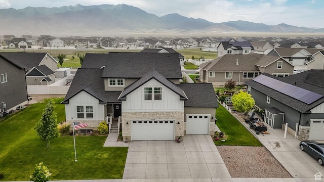 4655 N Ibapah St, Eagle Mountain, UT 84005 - view of front of property with stone siding, a residential view, board and batten siding, concrete driveway, and roof with shingles