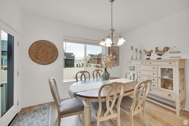 4655 N Ibapah St, Eagle Mountain, UT 84005 - dining space with light wood-style floors and a chandelier