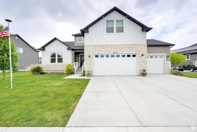 4655 N Ibapah St, Eagle Mountain, UT 84005 - view of front of house featuring board and batten siding, stone siding, a front yard, driveway, and a garage